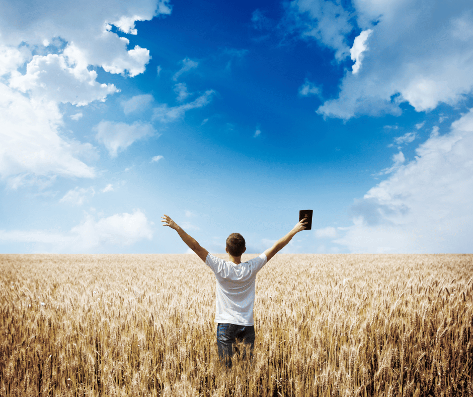 a Person in a field with their bible