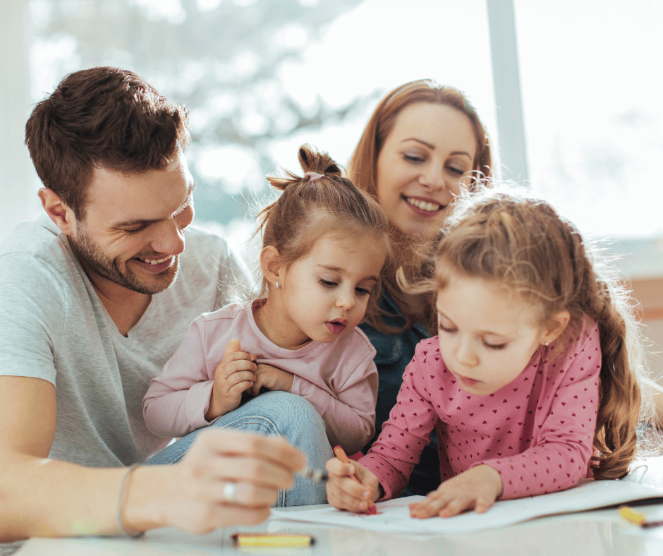 Parents with their Children coloring in our Free Christian Coloring book for kids